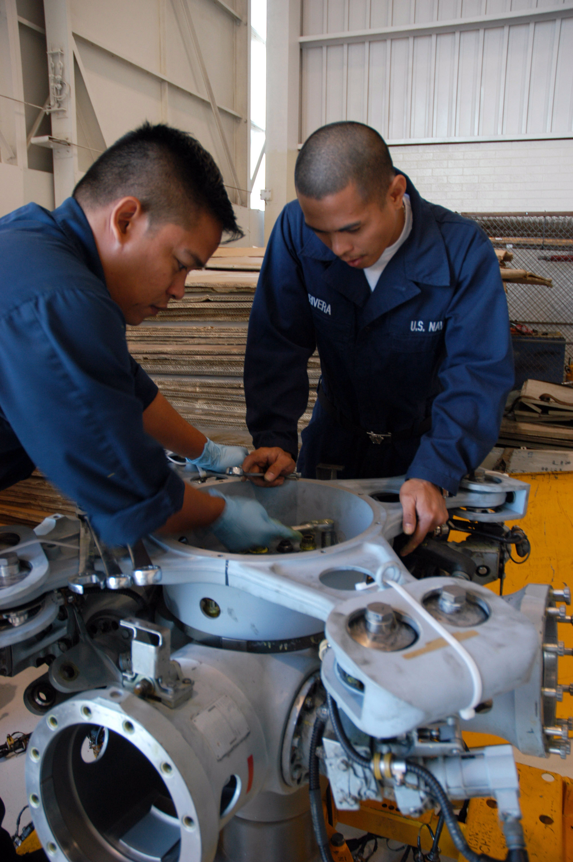 US Navy 061108-N-6652A-037 U.S. Navy Aviation Machinist's Mate 3rd Class Roy Hernandez, left, and Aviation Machinist's Mate Airman Jerry …