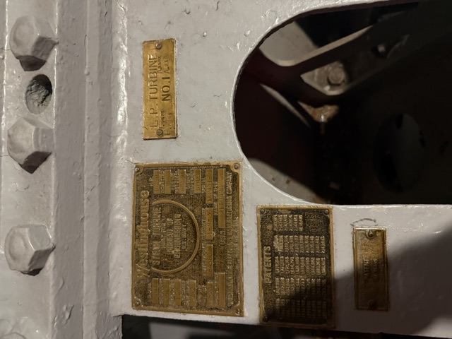 Westinghouse builder's nameplate documented aboard USS Alabama (BB-60) — Brass builder's plates on a Westinghouse steam turbine casing aboard USS Alabama, reading 'Westinghouse Steam Turbine, Built for Bureau of Engineering, U.S. Navy' alongside an 'L.P. Turbine No. 1' plate and a patents plate.