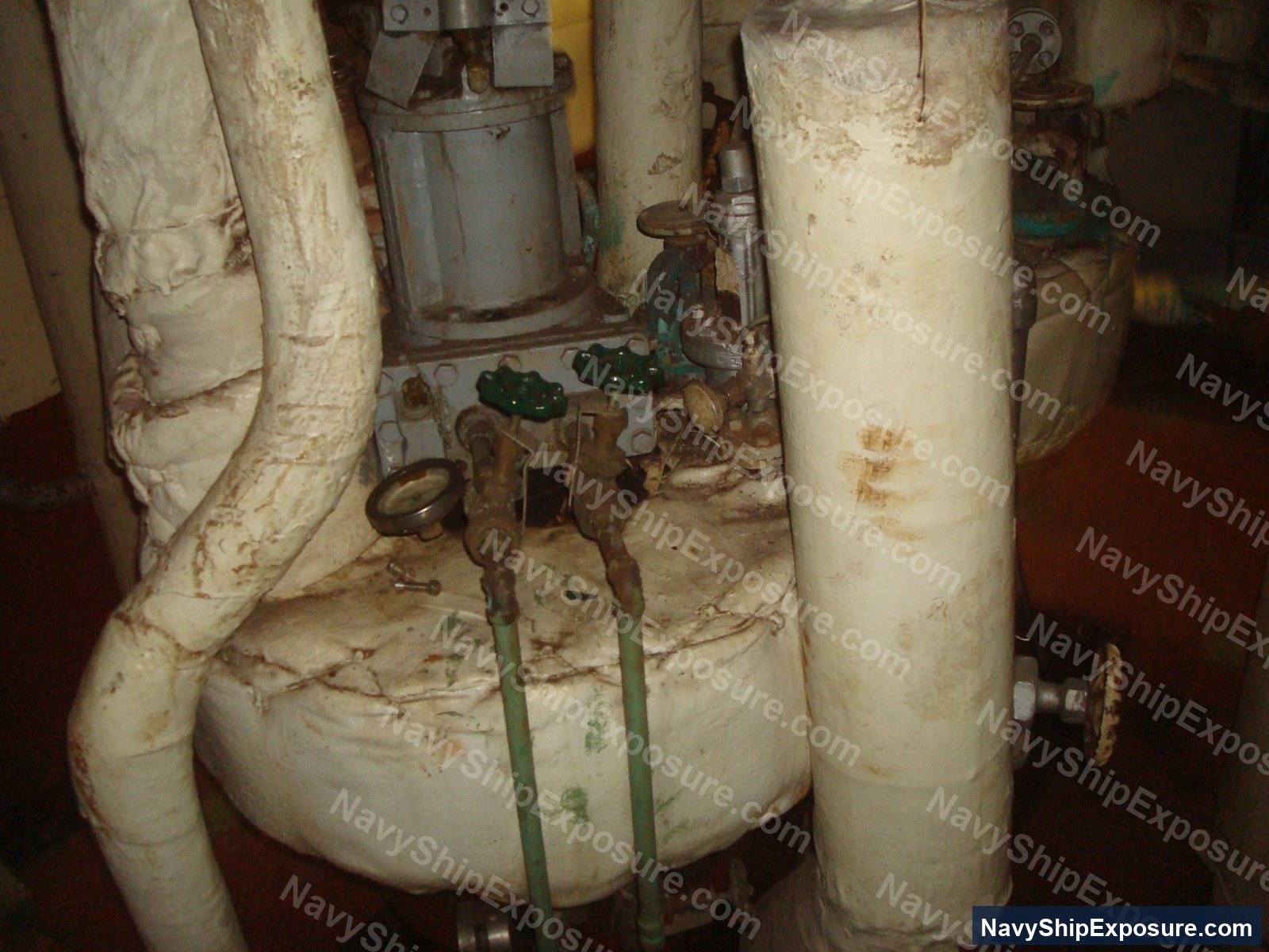 Engine room or machinery space aboard USS Midway showing insulated piping, valves, and mechanical equipment typical of a 1940s-era aircraft carrier's propulsion system.