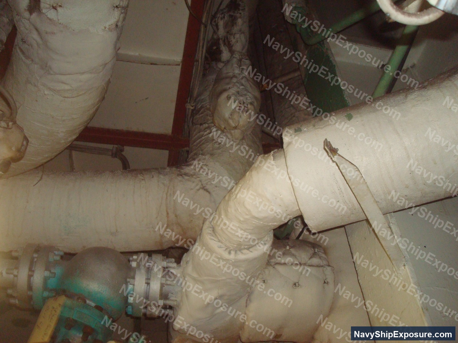 Insulated piping in an engine room or machinery space of USS Midway, showing wrapped thermal insulation typical of naval vessel steam systems from the Cold War era.