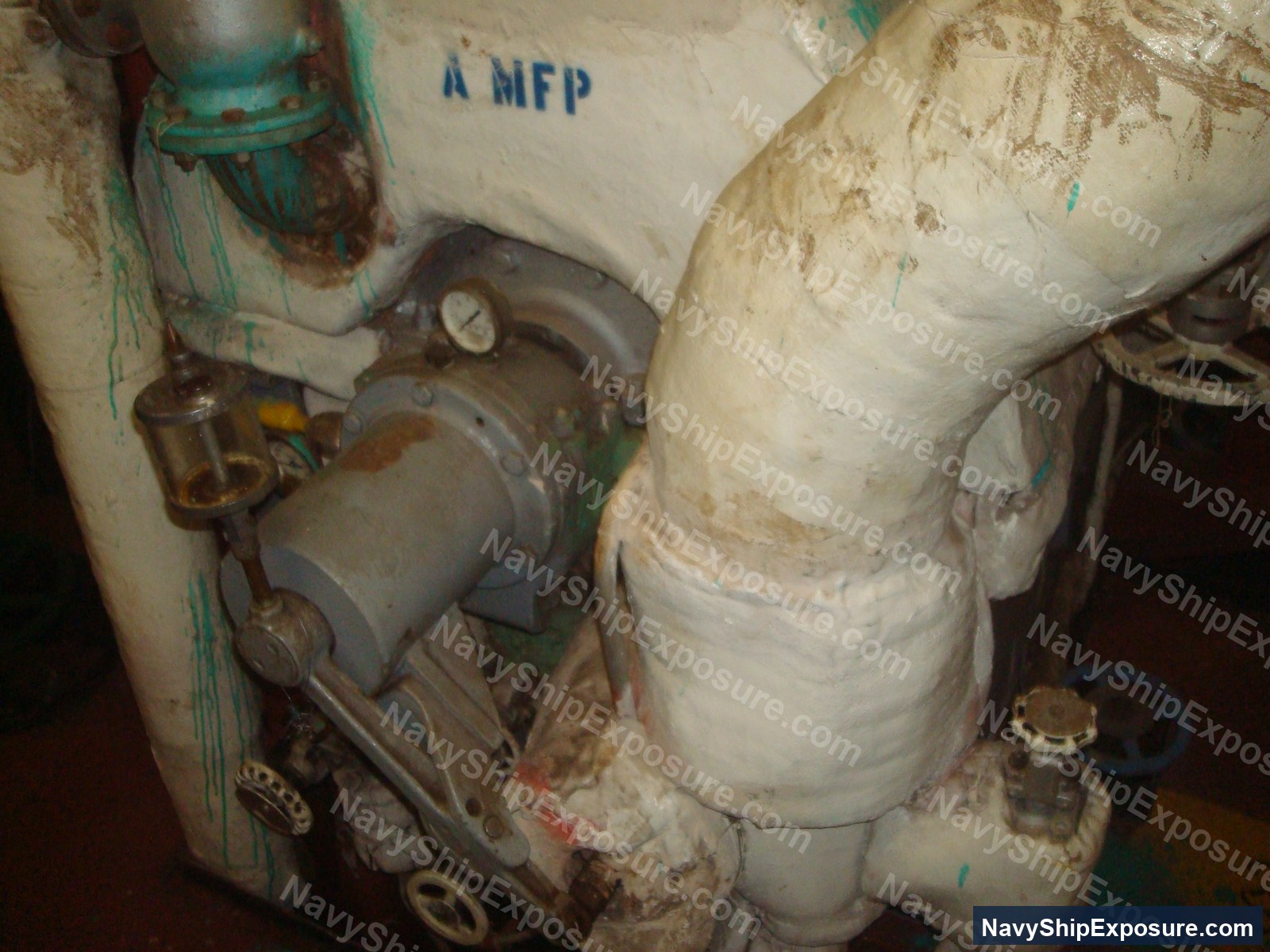 Engine room or machinery space photograph from USS Midway showing insulated piping, valves, gauges, and industrial equipment characteristic of 1940s-era naval propulsion systems.
