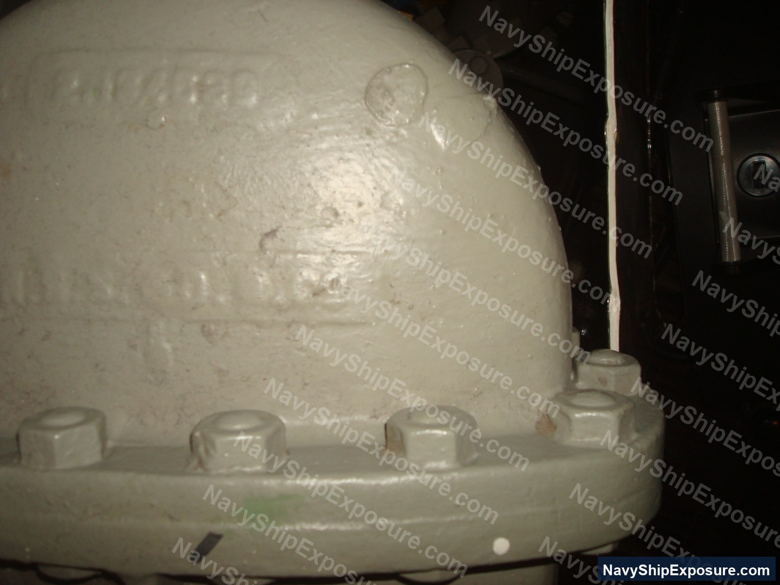 Close-up photograph of an insulated spherical vessel or tank with visible bolted connections and thermal insulation coating, likely from the USS Midway's engineering spaces.