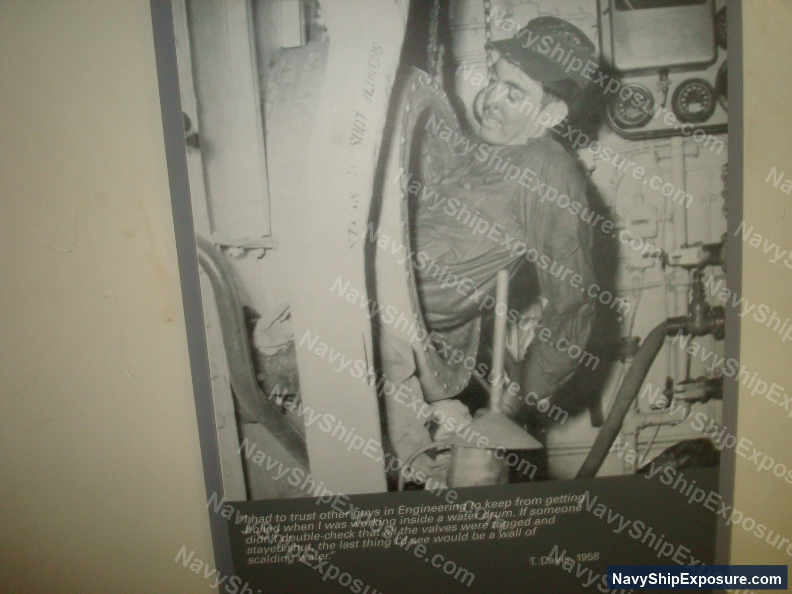 A sailor working inside a water drum in the boiler room of USS Midway in 1958, demonstrating the confined spaces and hazardous conditions where asbestos insulation was commonly present on naval vessels.