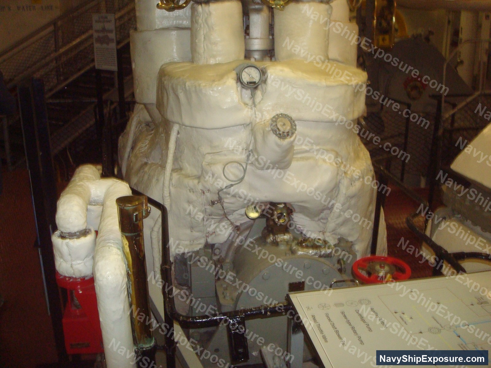 Engine room or machinery space aboard USS Midway showing wrapped piping, valves, gauges, and industrial equipment typical of 1940s-era naval propulsion systems.
